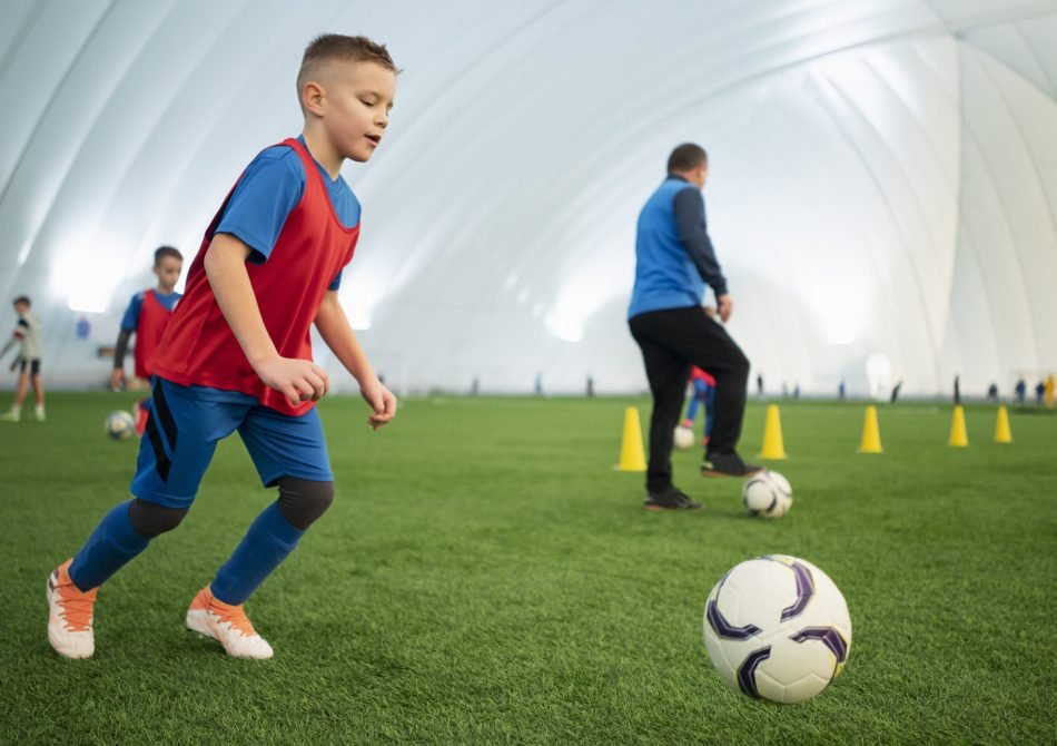 full-shot-kids-playing-football-field